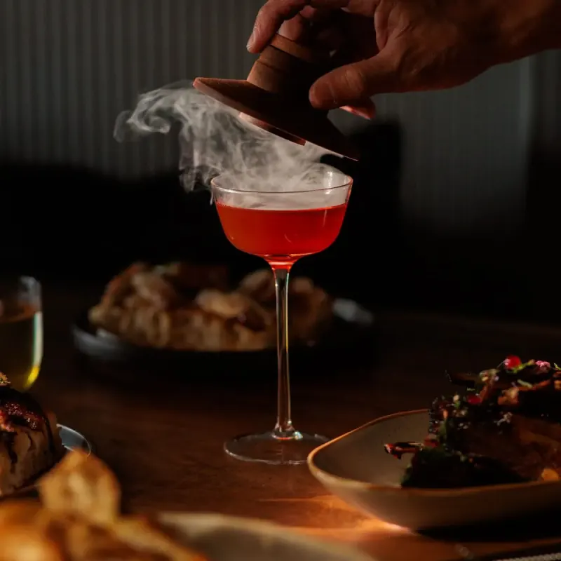 Smoked cocktail with plated dishes